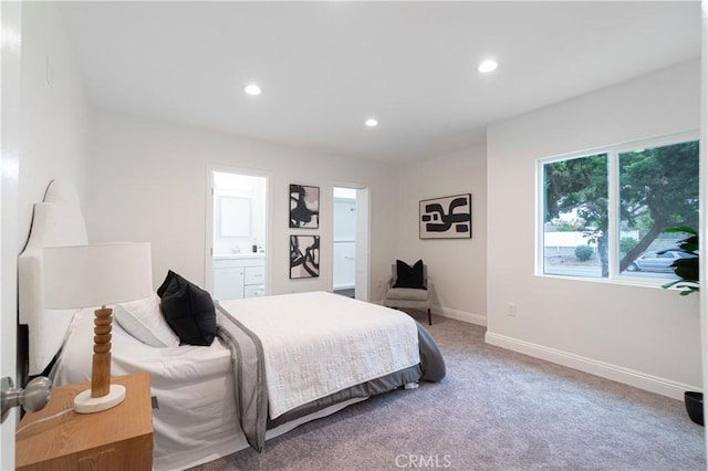 carpeted bedroom with recessed lighting, connected bathroom, and baseboards