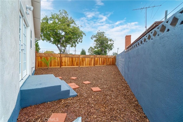 view of yard with a fenced backyard