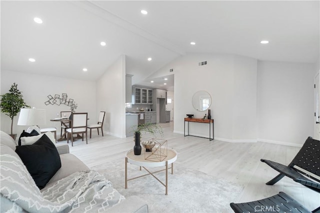 living room with high vaulted ceiling, recessed lighting, visible vents, baseboards, and light wood-style floors