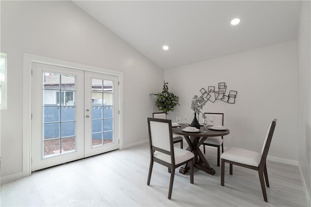 dining room featuring vaulted ceiling, french doors, a wealth of natural light, and recessed lighting