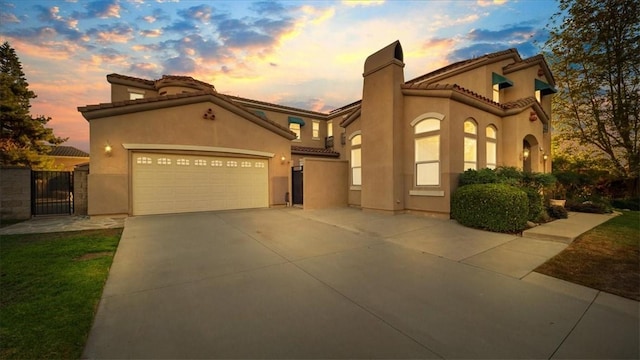 mediterranean / spanish-style home with a garage