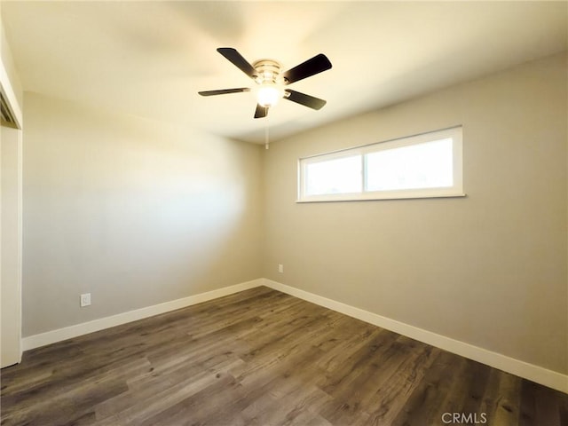 unfurnished room with ceiling fan and dark hardwood / wood-style flooring