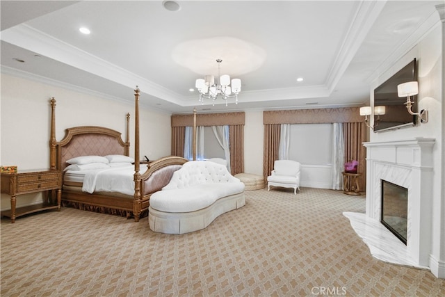 bedroom featuring a notable chandelier, a premium fireplace, a tray ceiling, and light colored carpet