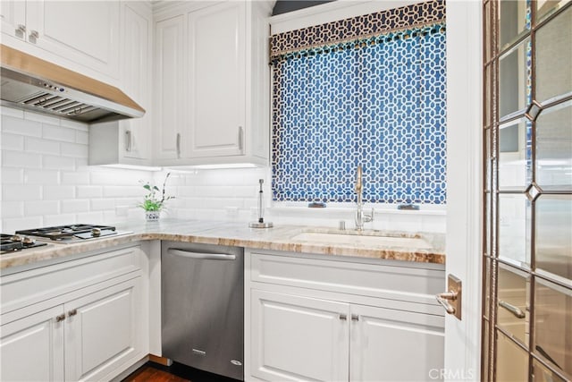 kitchen featuring white cabinets, stainless steel appliances, sink, and range hood