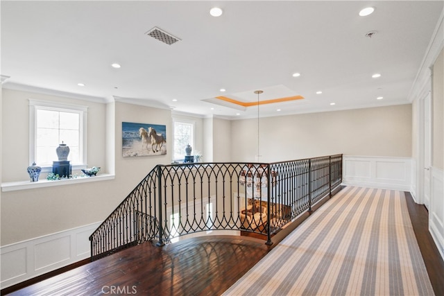 hallway with ornamental molding and wood-type flooring