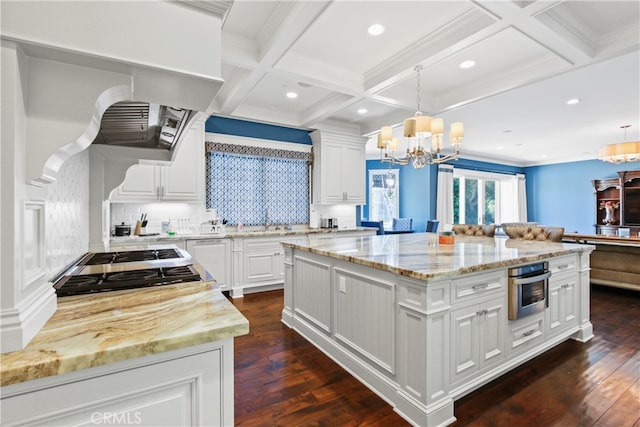 kitchen featuring dark wood-type flooring, a center island, hanging light fixtures, and stainless steel appliances