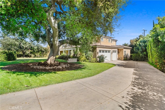 view of front of property featuring a front yard and a garage