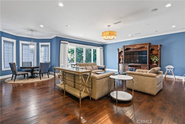 living room featuring crown molding, a notable chandelier, and dark hardwood / wood-style floors