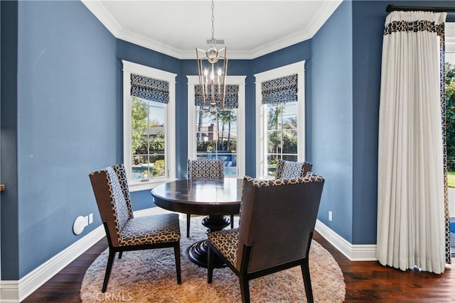 dining room featuring dark wood-type flooring, a notable chandelier, ornamental molding, and a wealth of natural light