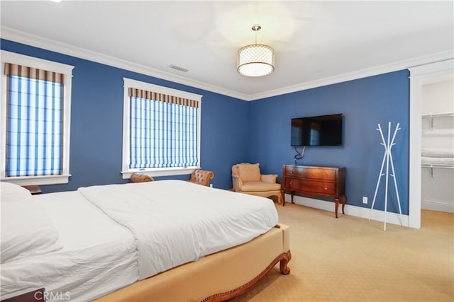 carpeted bedroom featuring a spacious closet, a closet, and ornamental molding