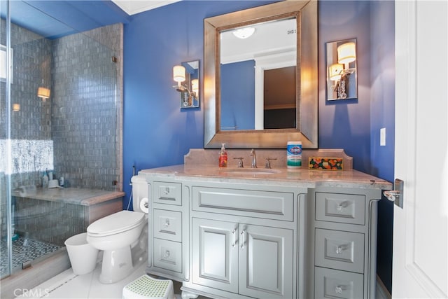 bathroom featuring vanity, tiled shower, toilet, and tile patterned flooring