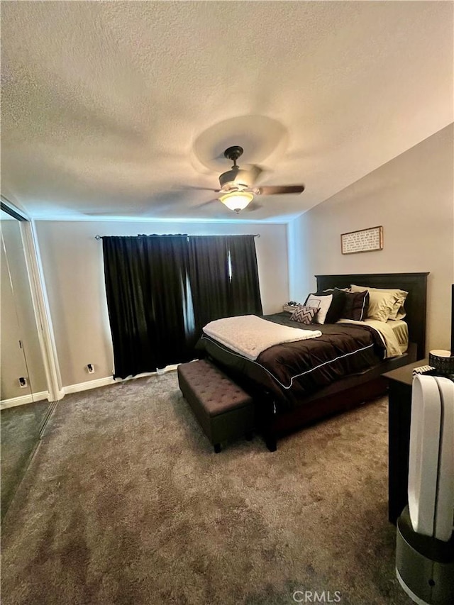 carpeted bedroom with a textured ceiling and ceiling fan