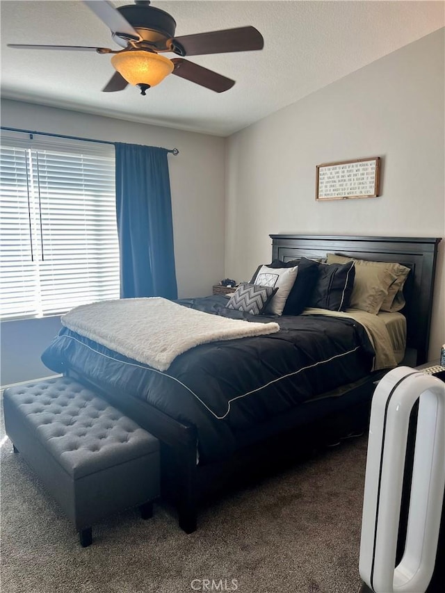 bedroom featuring carpet flooring, ceiling fan, and a textured ceiling