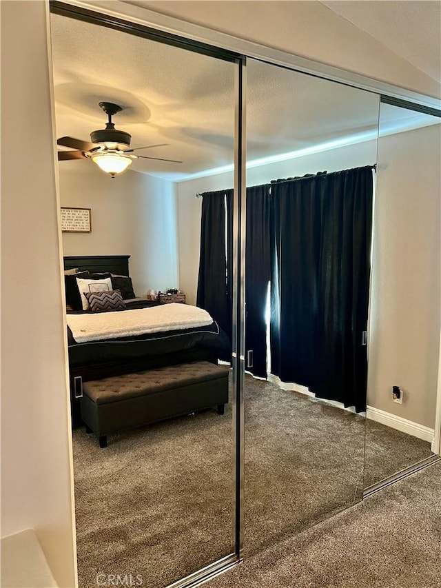 carpeted bedroom featuring a closet and ceiling fan