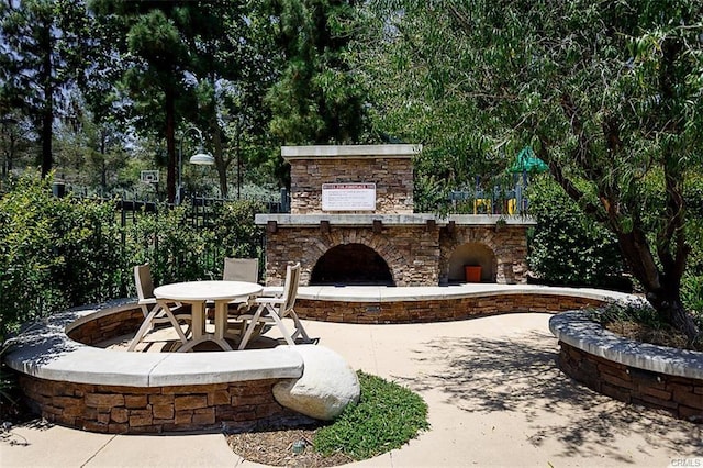 view of patio / terrace with an outdoor stone fireplace