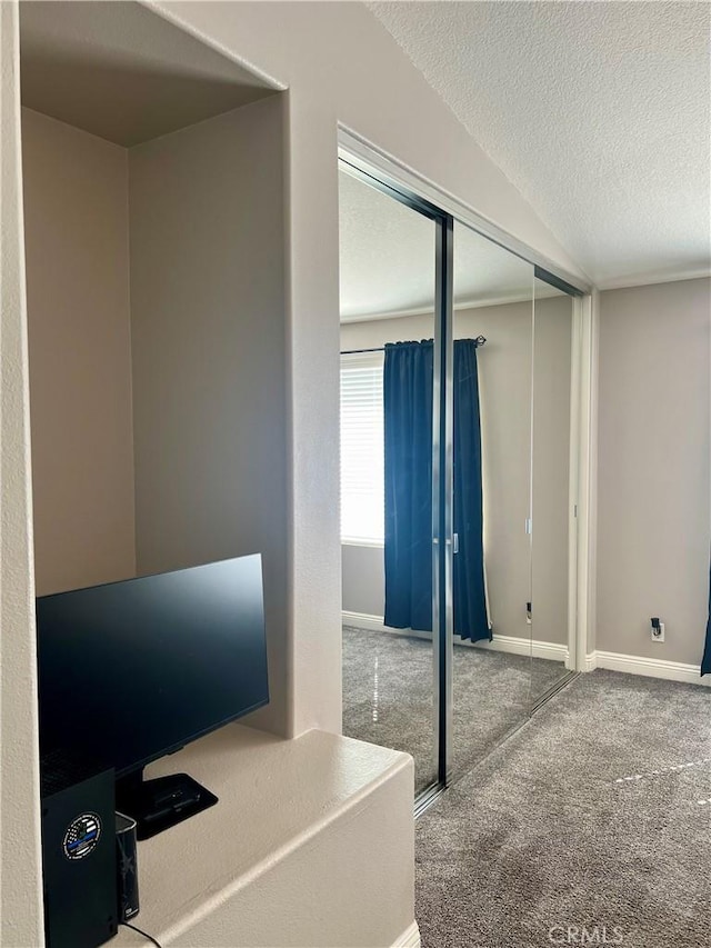 carpeted office with a textured ceiling