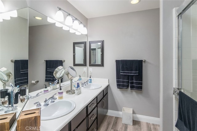 23014 Cheyenne Dr Unit 151, Valencia, CA 91354 - bathroom featuring double vanity, wood finished floors, baseboards, a tile shower, and recessed lighting