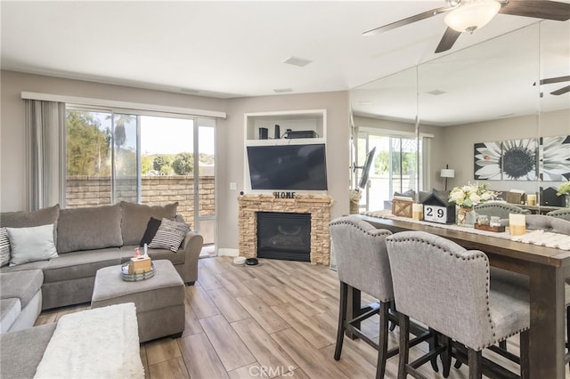 23014 Cheyenne Dr Unit 151, Valencia, CA 91354 - living room featuring ceiling fan, a fireplace, and wood finished floors