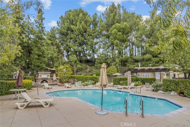 23014 Cheyenne Dr Unit 151, Valencia, CA 91354 - community pool featuring a patio and view of wooded area