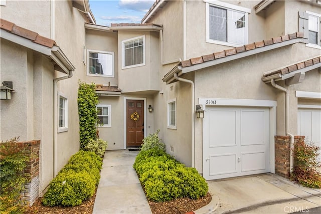 23014 Cheyenne Dr Unit 151, Valencia, CA 91354 - view of front of house with stucco siding and an attached garage