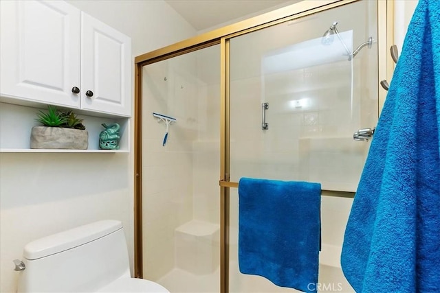 bathroom with an enclosed shower and toilet