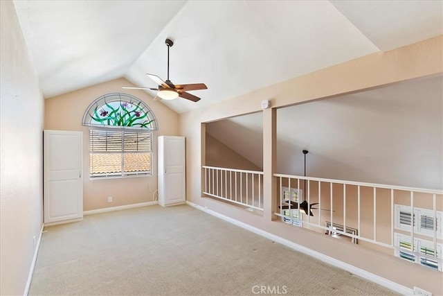 spare room with light colored carpet, ceiling fan, and lofted ceiling