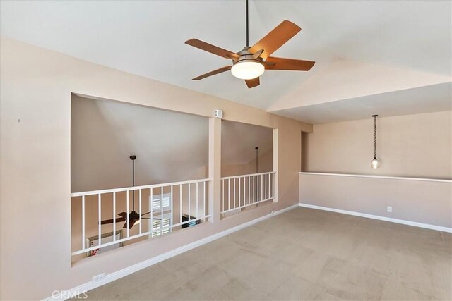 spare room featuring carpet flooring, ceiling fan, and lofted ceiling