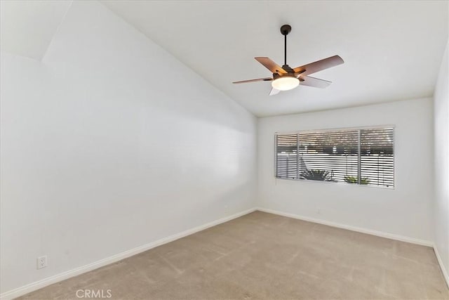 carpeted empty room featuring ceiling fan and lofted ceiling