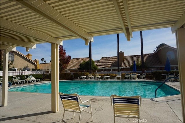 view of swimming pool featuring a patio area and a pergola