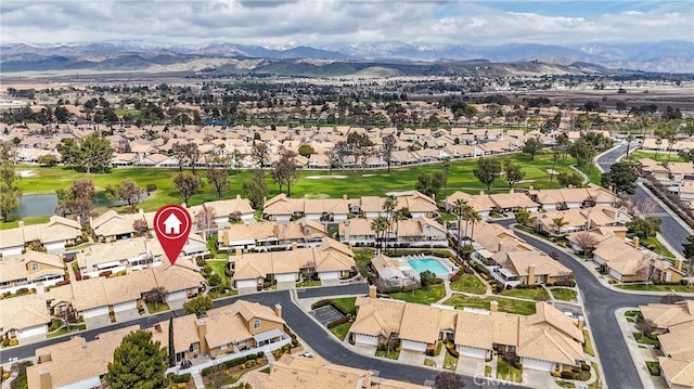 birds eye view of property with a mountain view, a residential view, and golf course view