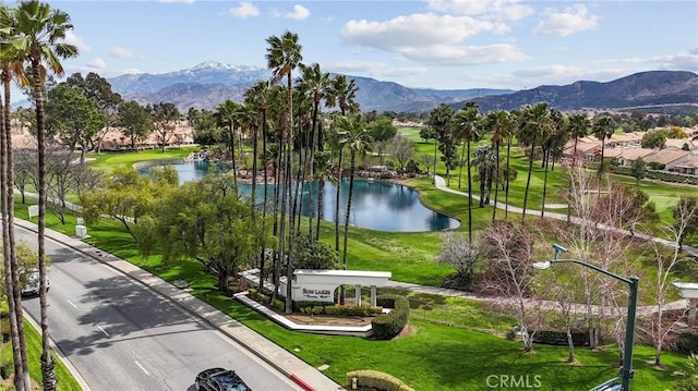 view of community featuring a water and mountain view and a lawn