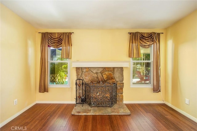 unfurnished living room featuring a fireplace and hardwood / wood-style floors