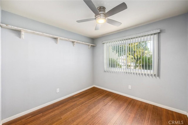 empty room featuring hardwood / wood-style floors and ceiling fan