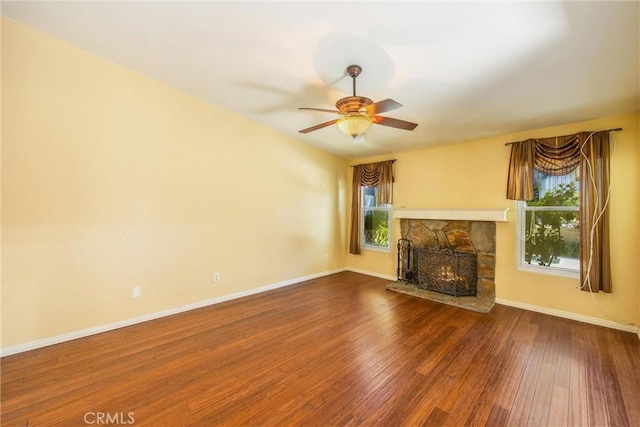 unfurnished living room with a fireplace, ceiling fan, and hardwood / wood-style floors