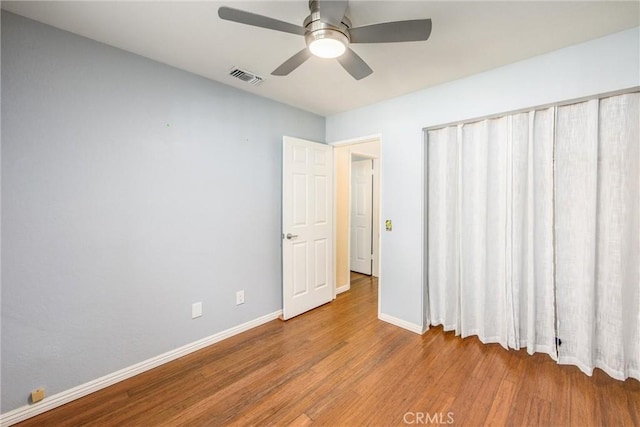 unfurnished bedroom featuring ceiling fan and light hardwood / wood-style flooring