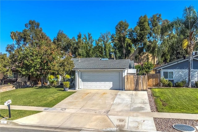 view of front of home with a garage and a front lawn