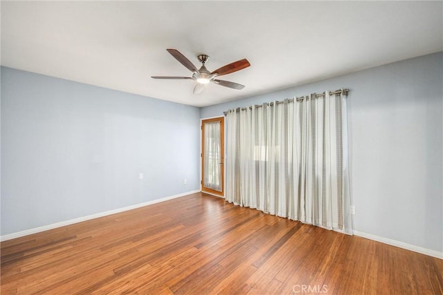 unfurnished room featuring hardwood / wood-style floors and ceiling fan