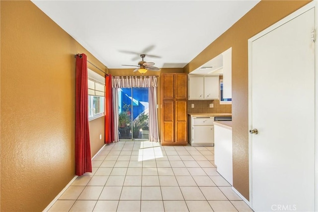 kitchen with light tile patterned floors, backsplash, and ceiling fan