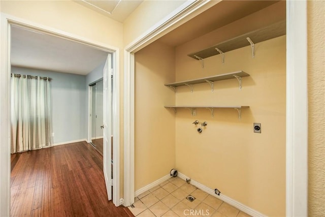 clothes washing area with electric dryer hookup, gas dryer hookup, wood-type flooring, and washer hookup