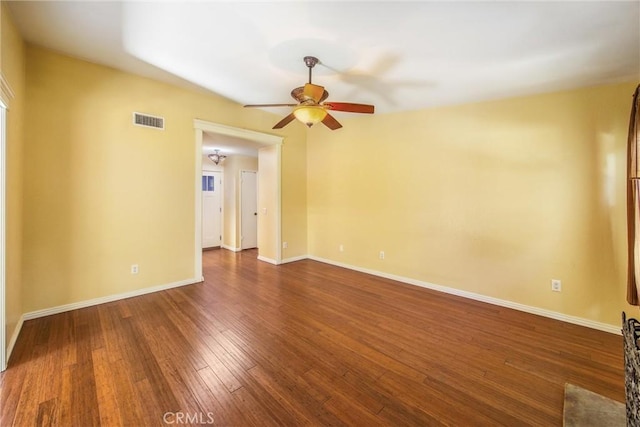 unfurnished room with dark hardwood / wood-style floors and ceiling fan