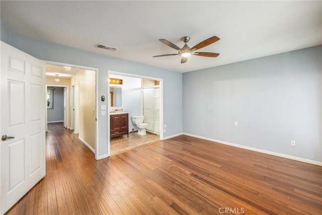 unfurnished room with wood-type flooring and ceiling fan