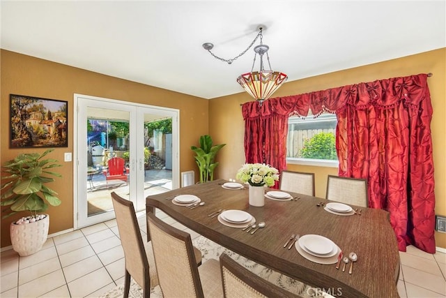 dining space with french doors and light tile patterned floors