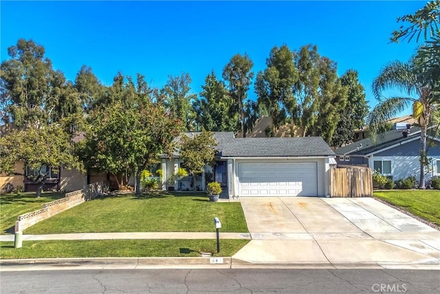 view of front of home with a front yard and a garage