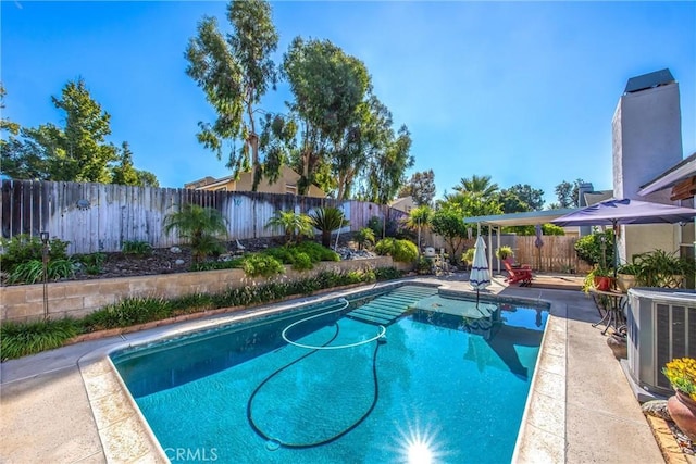 view of swimming pool featuring cooling unit and a patio