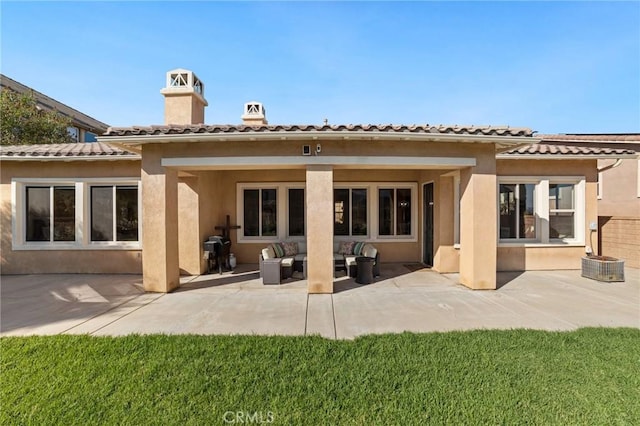 rear view of house with a patio area, an outdoor living space, and a yard