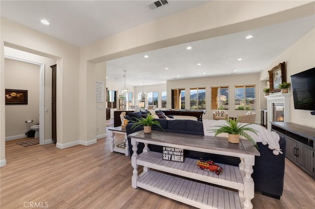 living room with light hardwood / wood-style floors and billiards