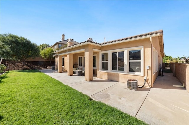 back of house with a yard, cooling unit, a patio, and an outdoor hangout area