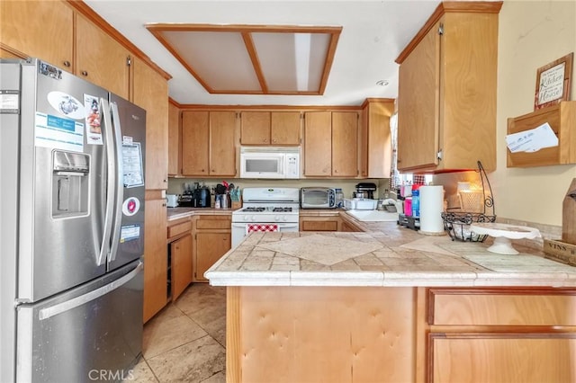6277 Linda Lee Dr, Yucca Valley, CA 92284 - kitchen featuring white appliances, a peninsula, and a sink