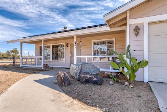 6277 Linda Lee Dr, Yucca Valley, CA 92284 - doorway to property with covered porch and a garage