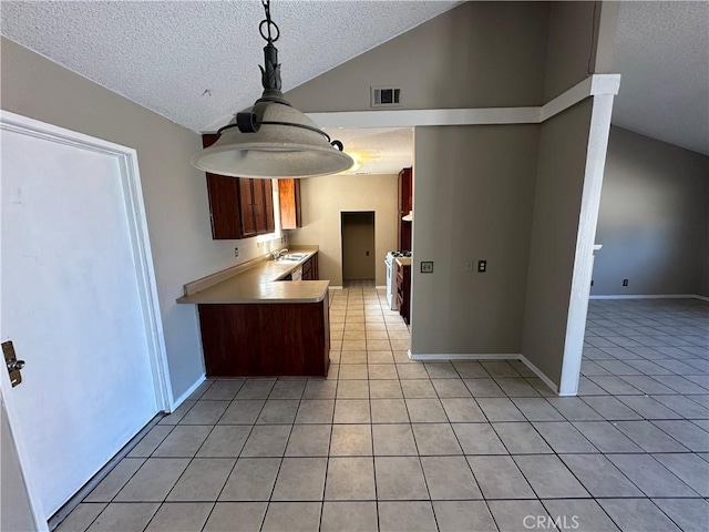 kitchen featuring light tile patterned floors, visible vents, pendant lighting, and light countertops